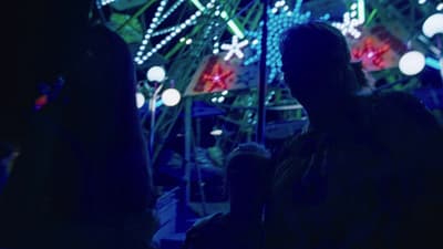 a group of people standing in front of a ferris wheel