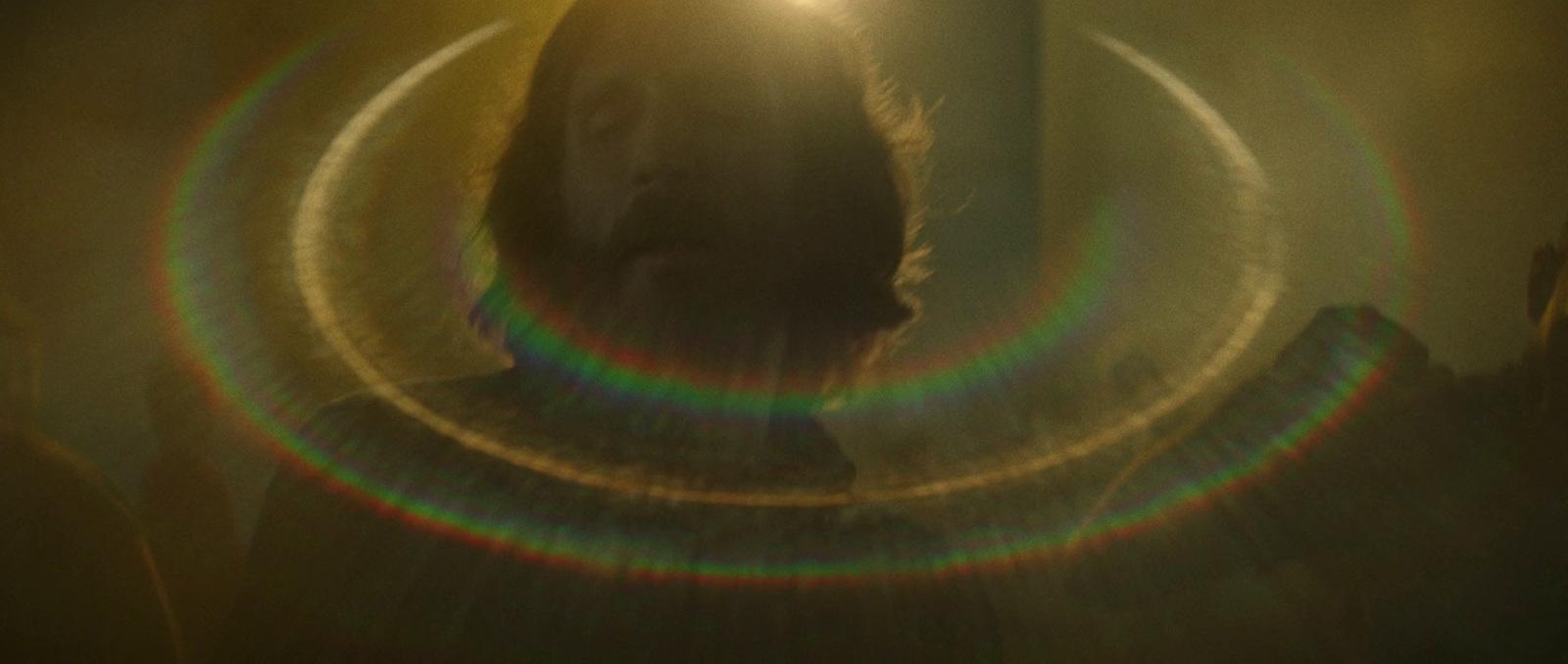 a person standing in front of a light that is shining