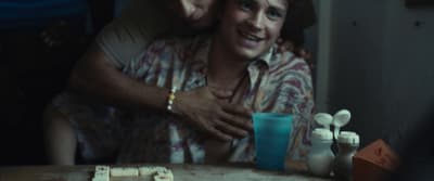 a man and a woman hugging at a table