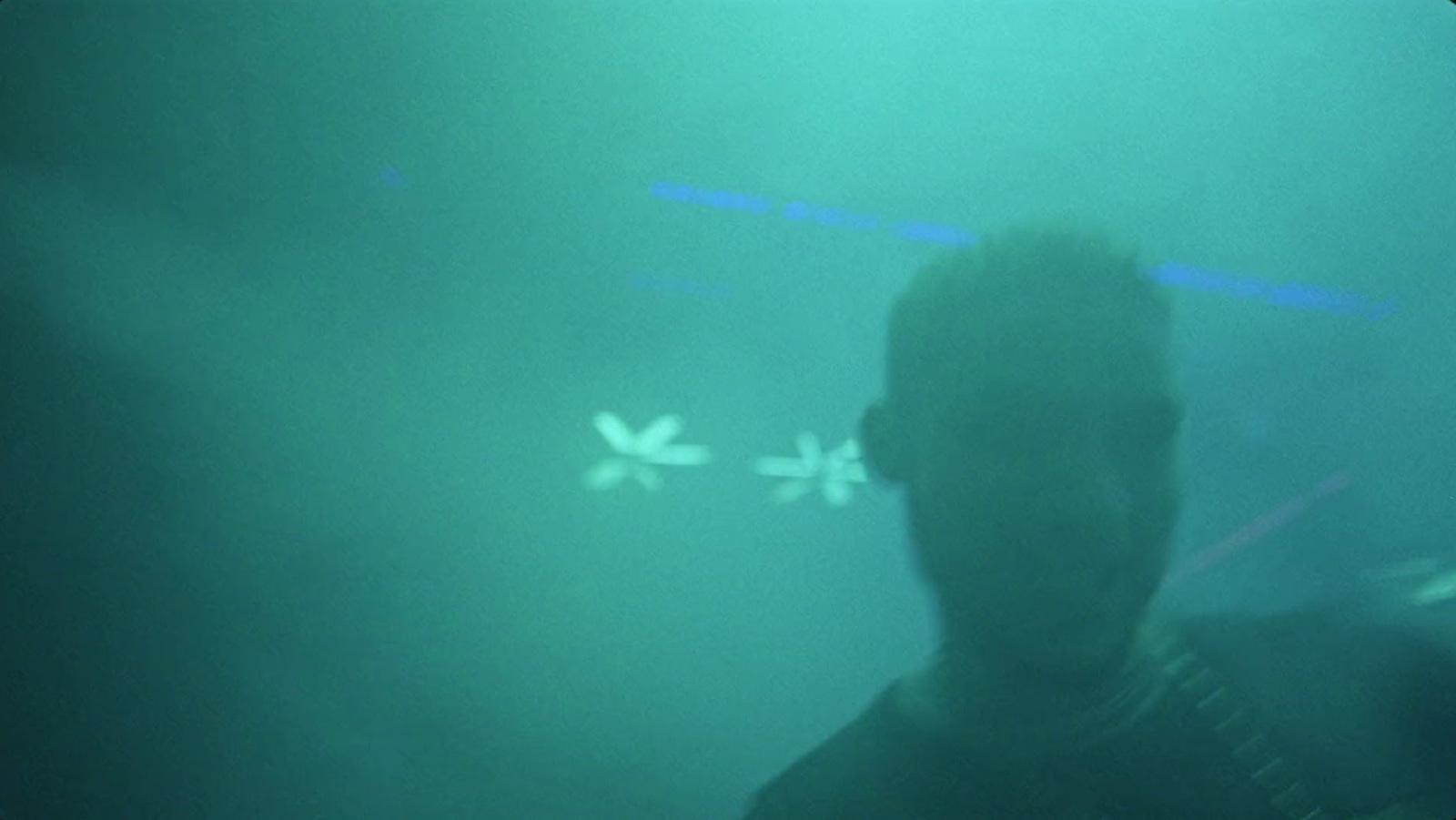 a man standing in front of a green light