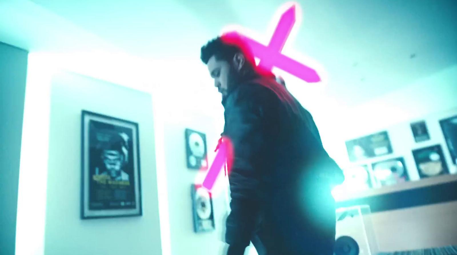 a man in a room with a neon cross on his head