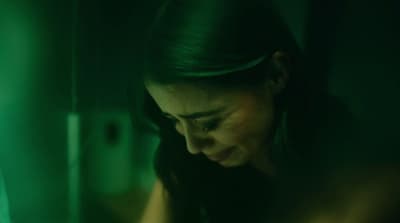 a woman looking down at her cell phone