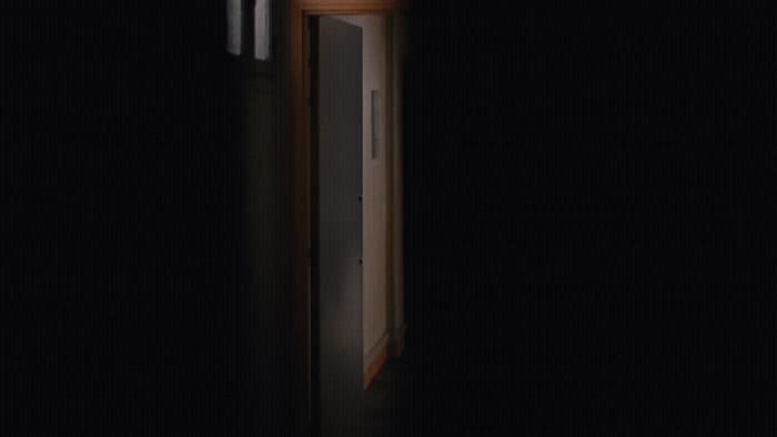 an open door in a dark room with a clock on it