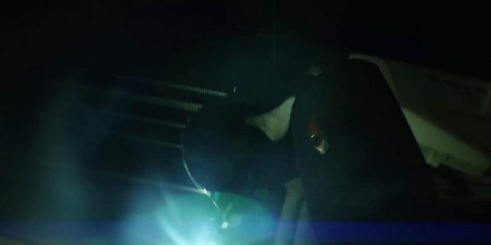 a person sitting on a bench in the dark