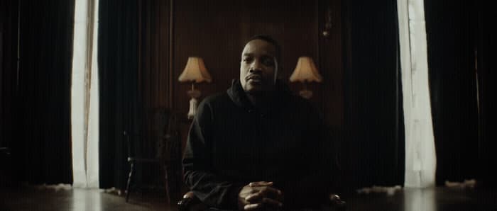 a man sitting on a chair in a room