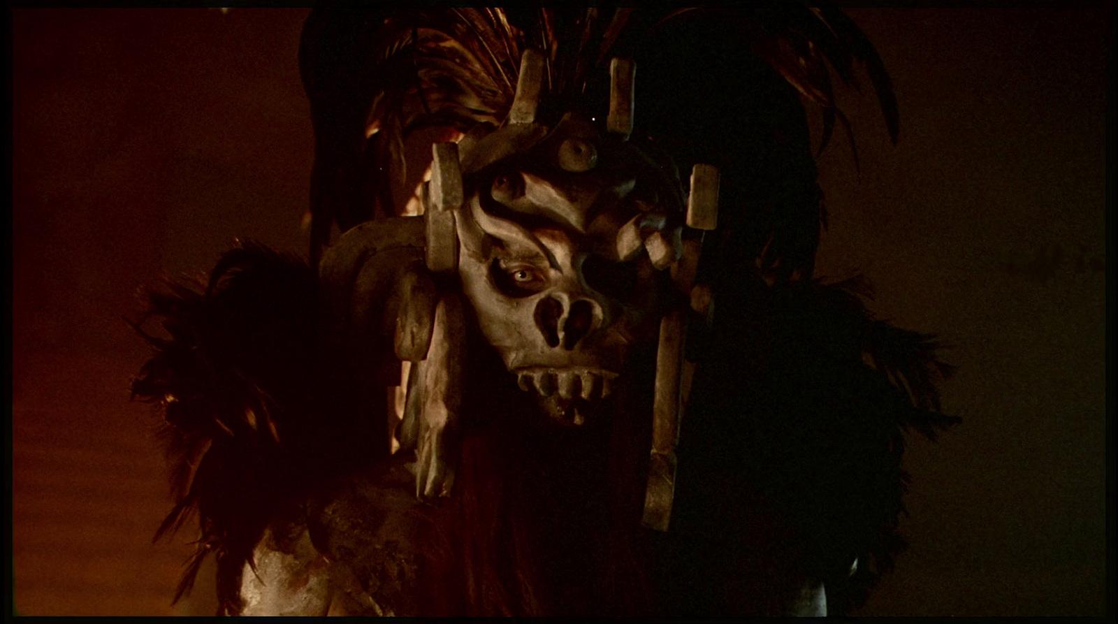 a creepy looking mask with feathers on it