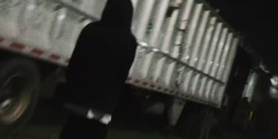 a person standing next to a truck in the dark