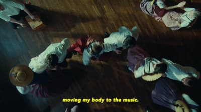 a group of people standing on top of a wooden floor