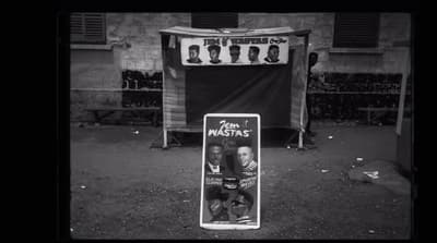 a black and white photo of a sign in front of a building