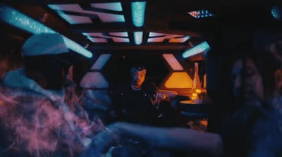 a group of people sitting around a table in a room