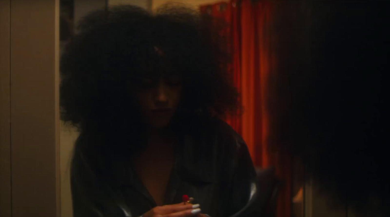 a woman smoking a cigarette in a dark room