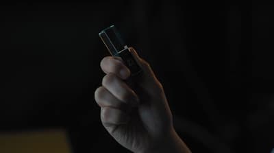 a person holding a lighter in their hand