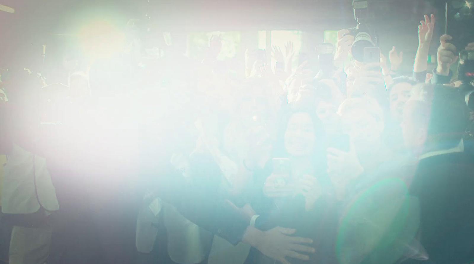 a group of people standing around each other