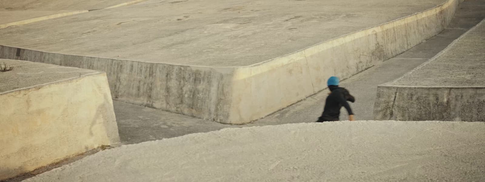 a person walking up a ramp in a skate park