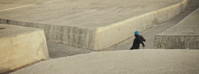 a person walking up a ramp in a skate park