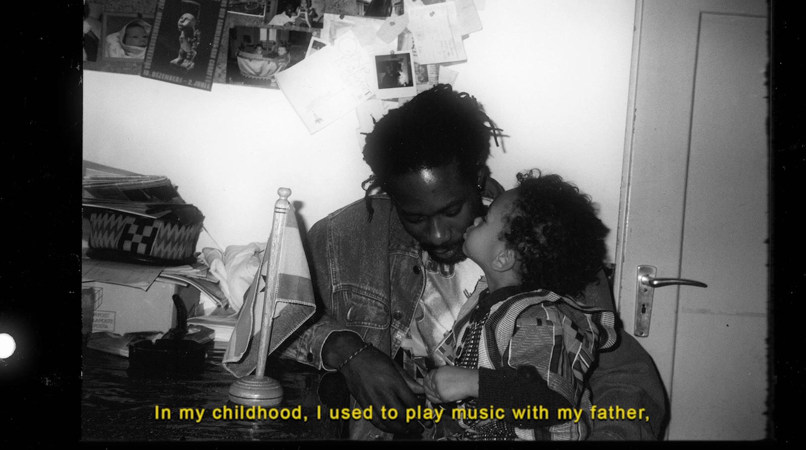 a black and white photo of a man kissing a little girl