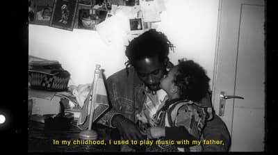 a black and white photo of a man kissing a little girl