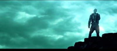 a man standing on top of a rocky cliff