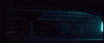 a dark room with a door and a light in it