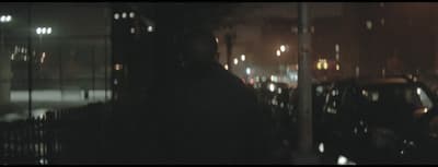 a blurry image of a person standing in a dark room