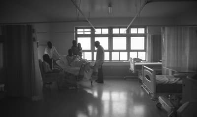 a black and white photo of a hospital room
