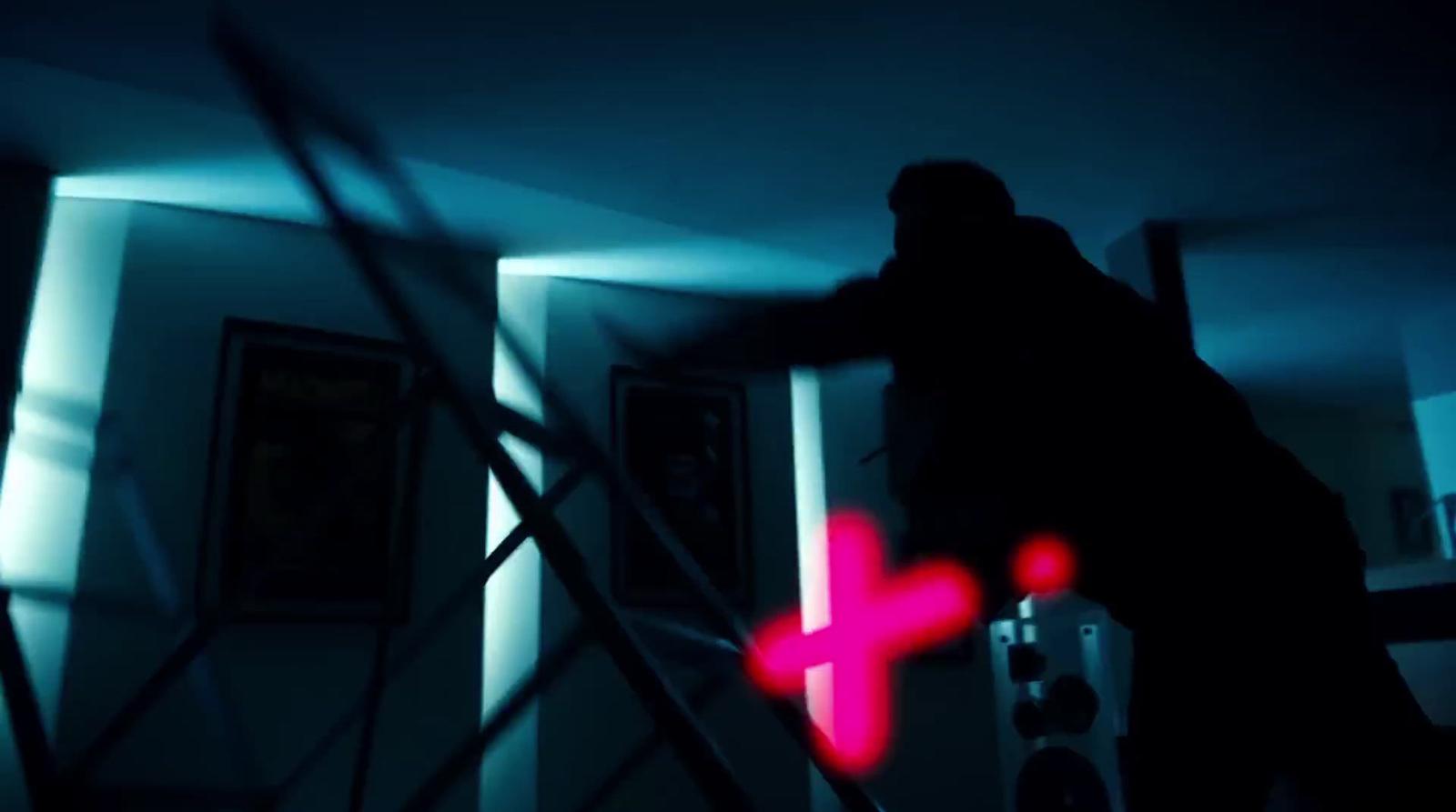 a person standing in a room with a cross on the wall