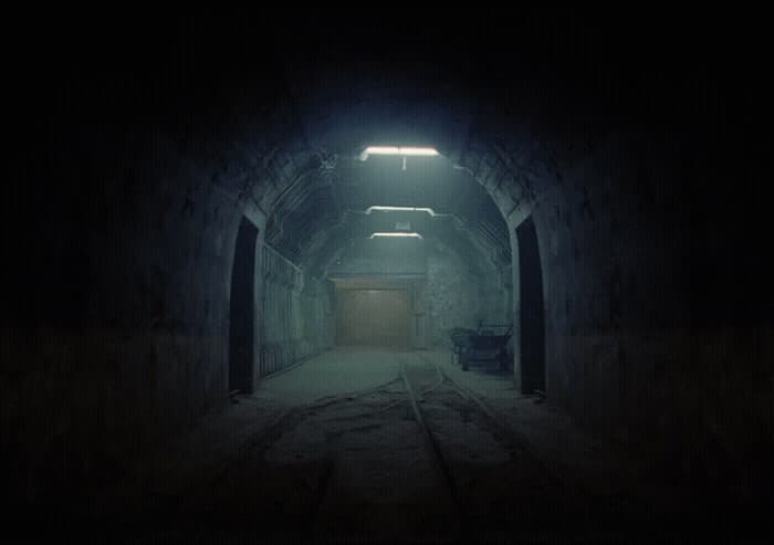 a dark tunnel with a light at the end