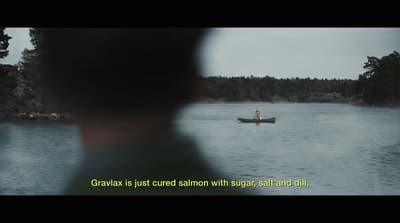 a person in a small boat on a lake