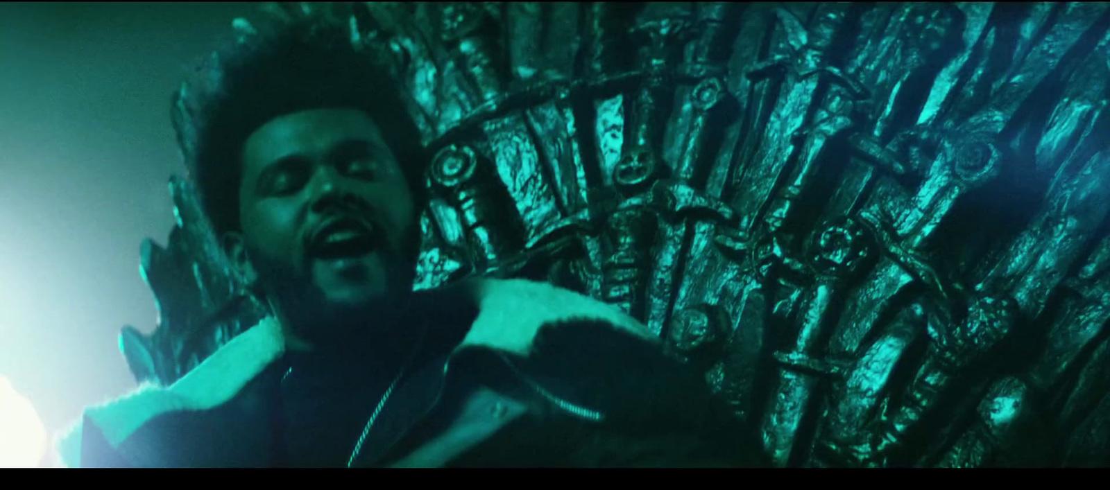 a man standing in front of a iron throne