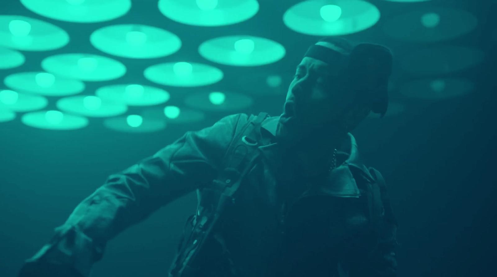 a man standing in front of a green light