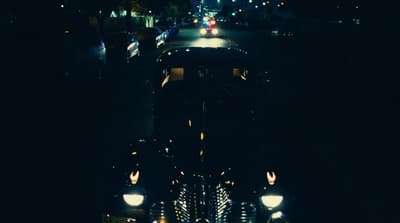 a train traveling down train tracks at night