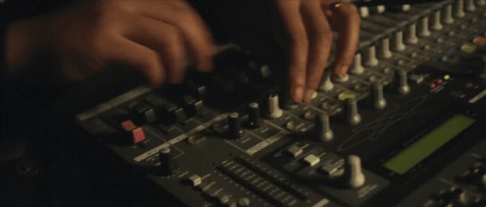 a person using a mixing console in a recording studio