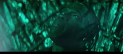 a man with his head in the air in front of a green background