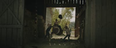 a group of people standing inside of a barn