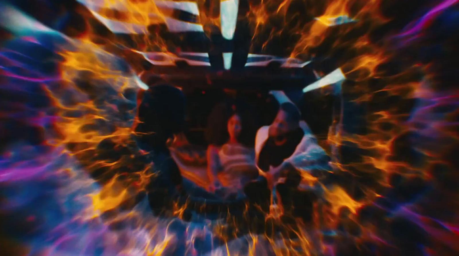 a close up of a person's face with fire and flames in the background