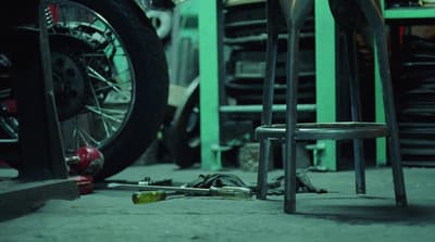 a pair of chairs sitting next to a pile of tools