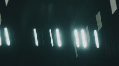 a black and white photo of some lights in the dark