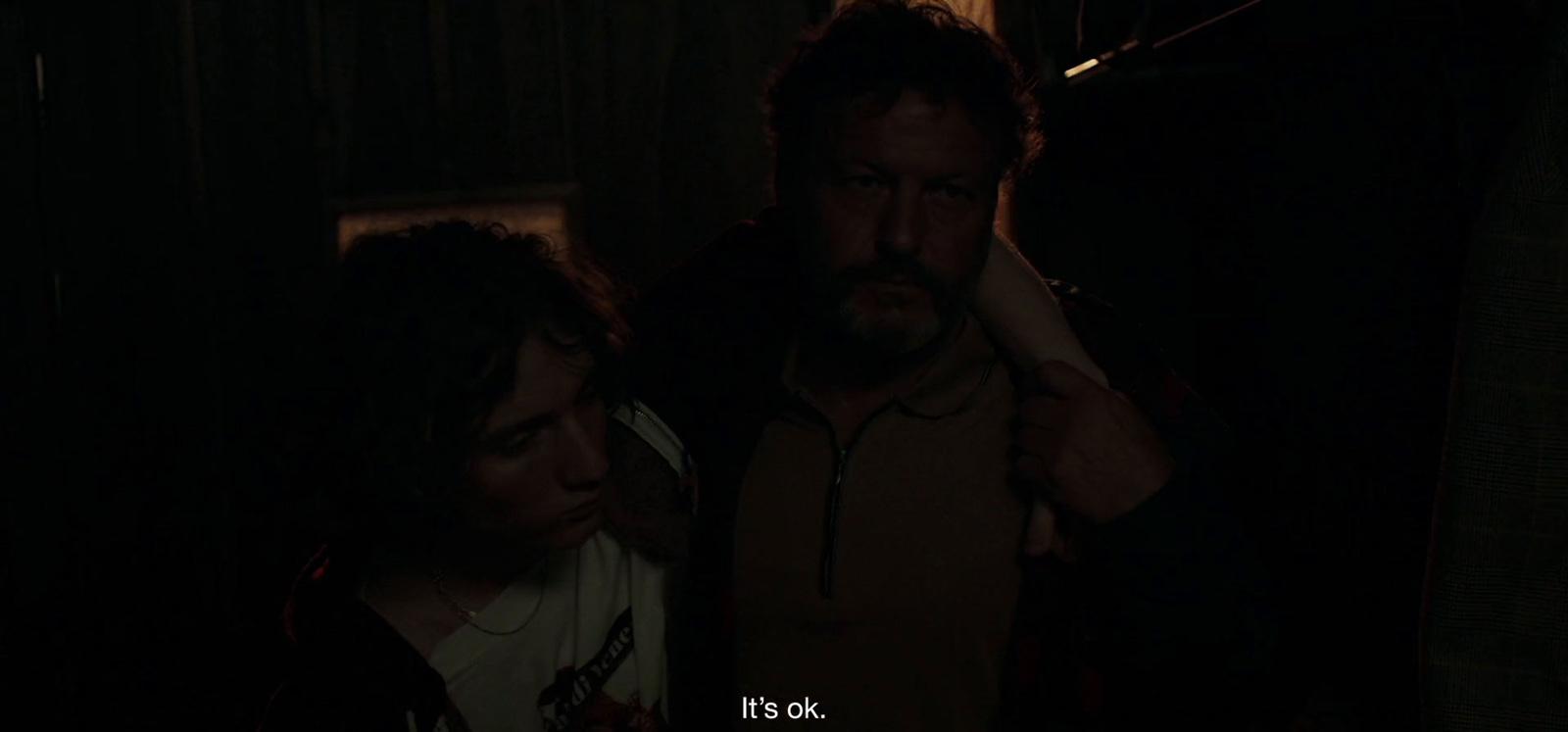 a man and a woman standing in a dark room