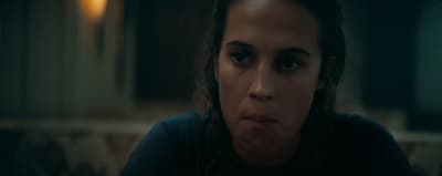 a woman making a face in a dark room