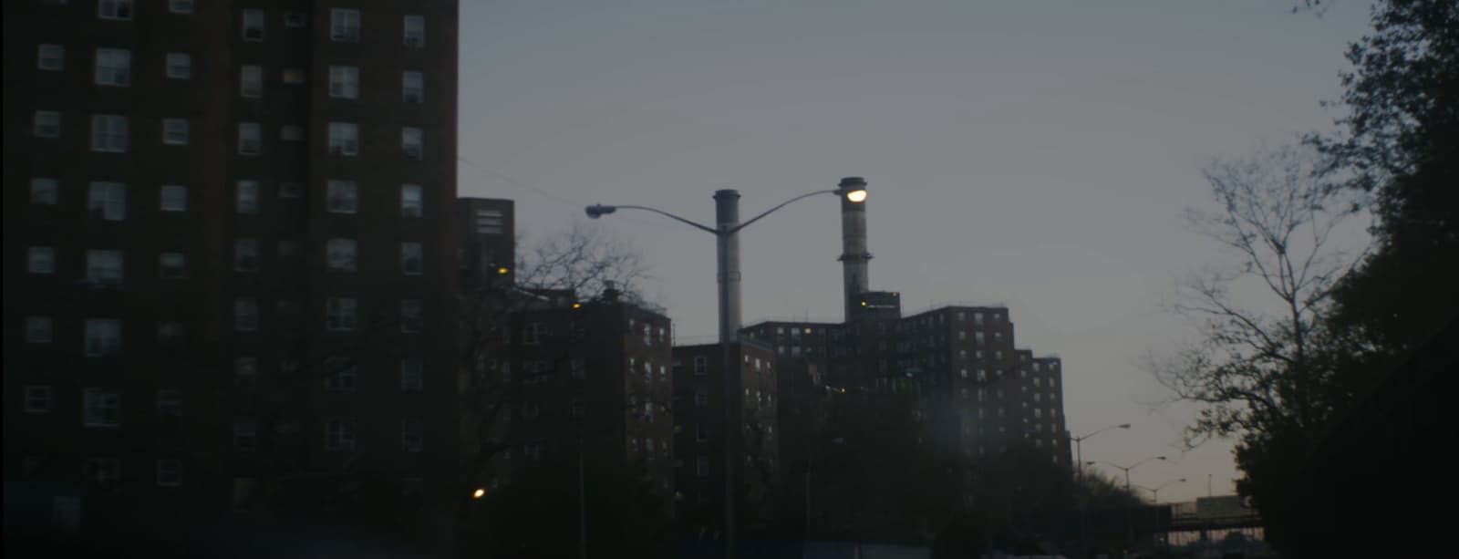 a view of a city street with tall buildings in the background