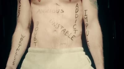 a man with a lot of tattoos on his chest