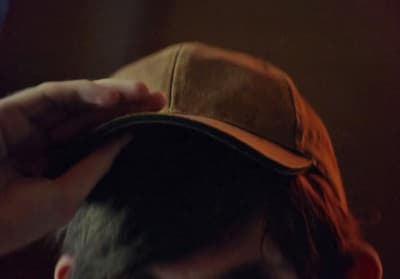 a close up of a person wearing a hat