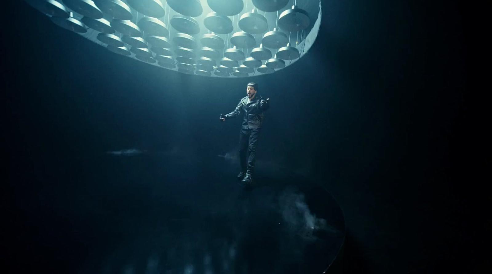 a man standing in the middle of a dark room