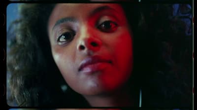 a close up of a person with red eyes
