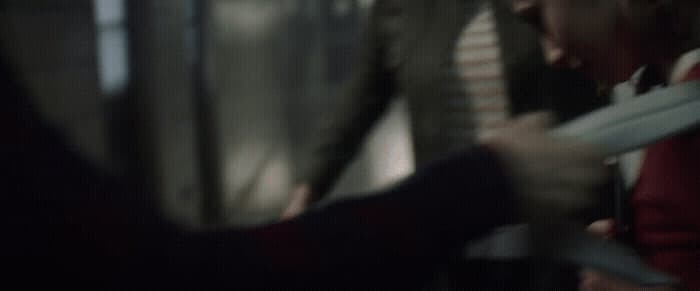 a blurry photo of a person holding a pair of scissors