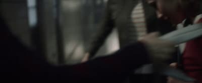 a blurry photo of a person holding a pair of scissors