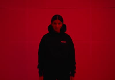 a person standing in front of a red wall