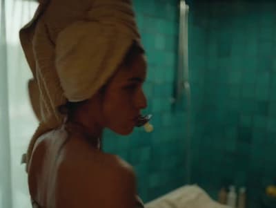 a woman with a towel on her head in a bathroom