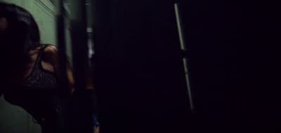 a woman standing in a dark room in the dark