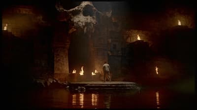 a man standing on a rock in a cave